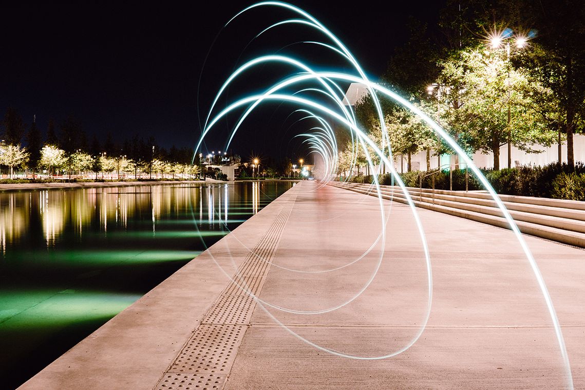 Light at night beside a river, by Yannis Papanastasopoulos presented by unsplash